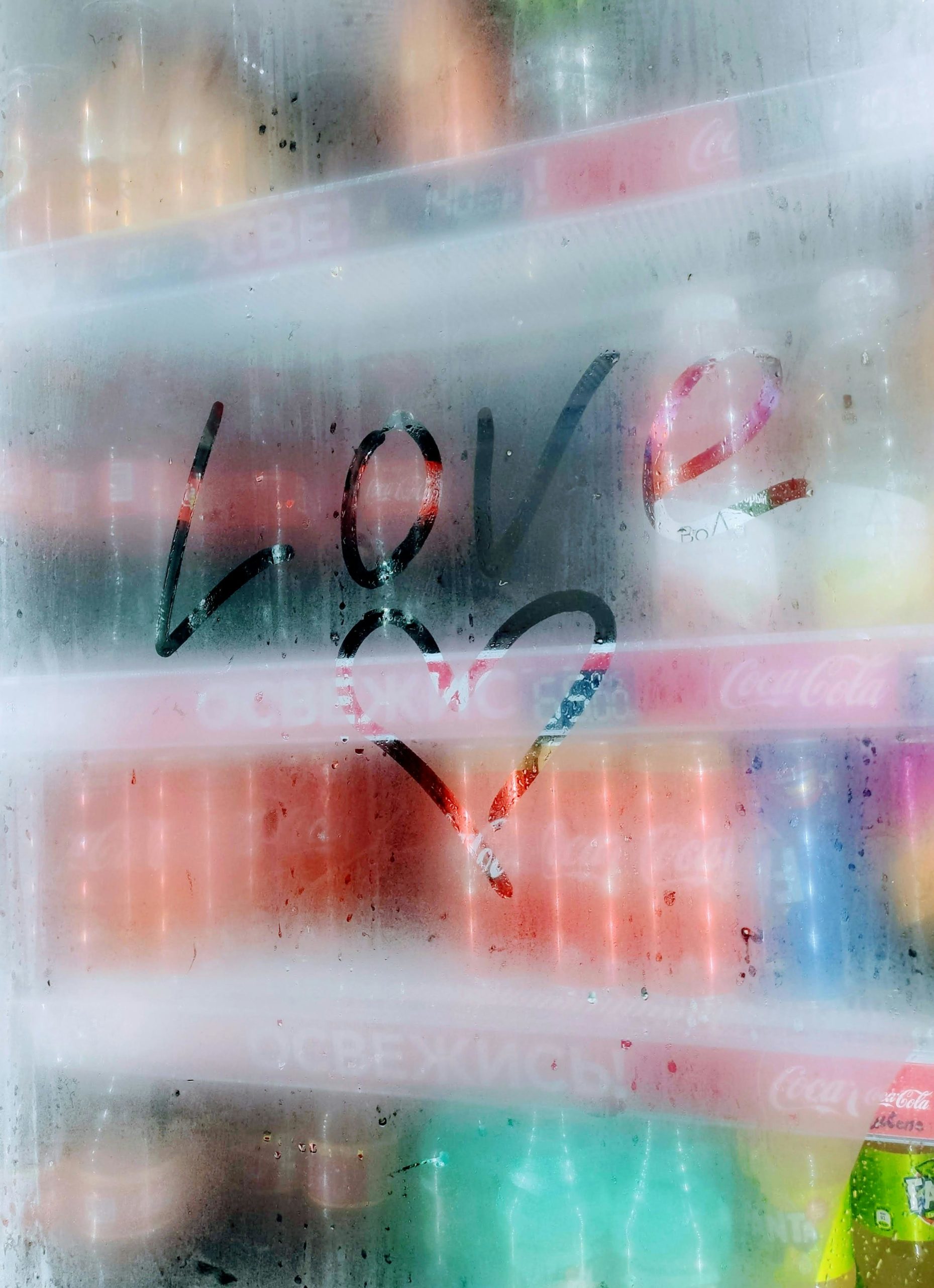 Heartfelt message on a moist vending machine glass showing love and creativity.